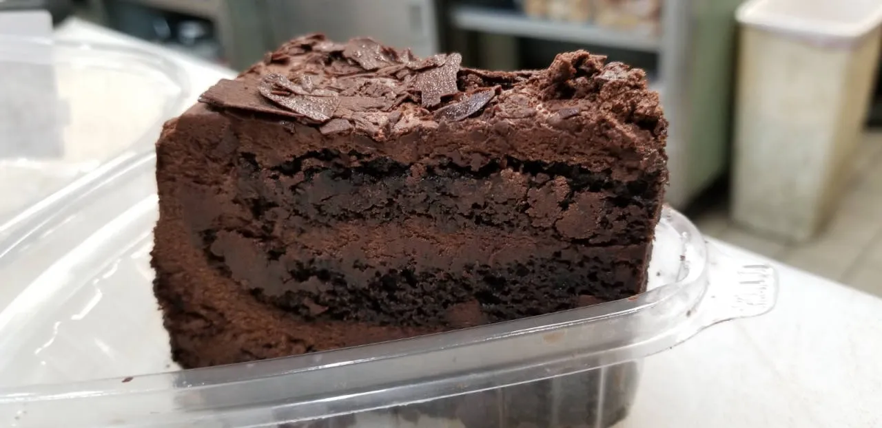 Slice of rich homemade chocolate cake