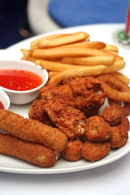 Platter of fries, mozzarella sticks, wings and broccoli bites
