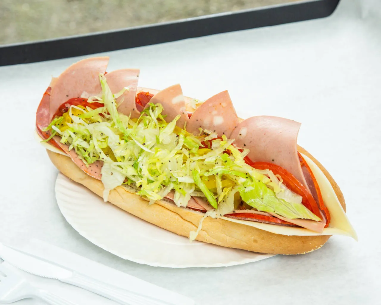 Cold Italian sub with salami, mortadella, lettuce and tomato